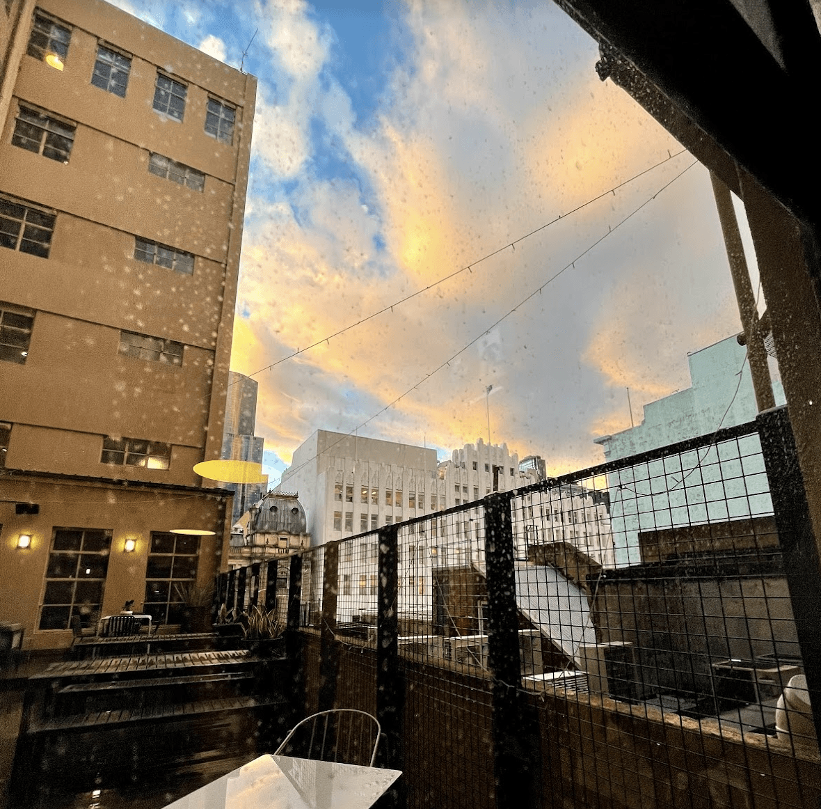 Cover photo for blog post titled How to Create a Productive Home Office in Your Share House. Melbourne city skyline at sunset on a rainy day.