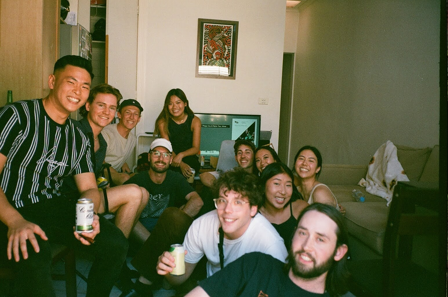 Cover photo for blog post, picture shows a group of smiling friends sitting inside a Collingwood Sharehouse